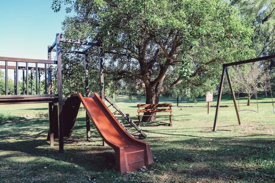 Sector de juegos con tobogán y hamacas