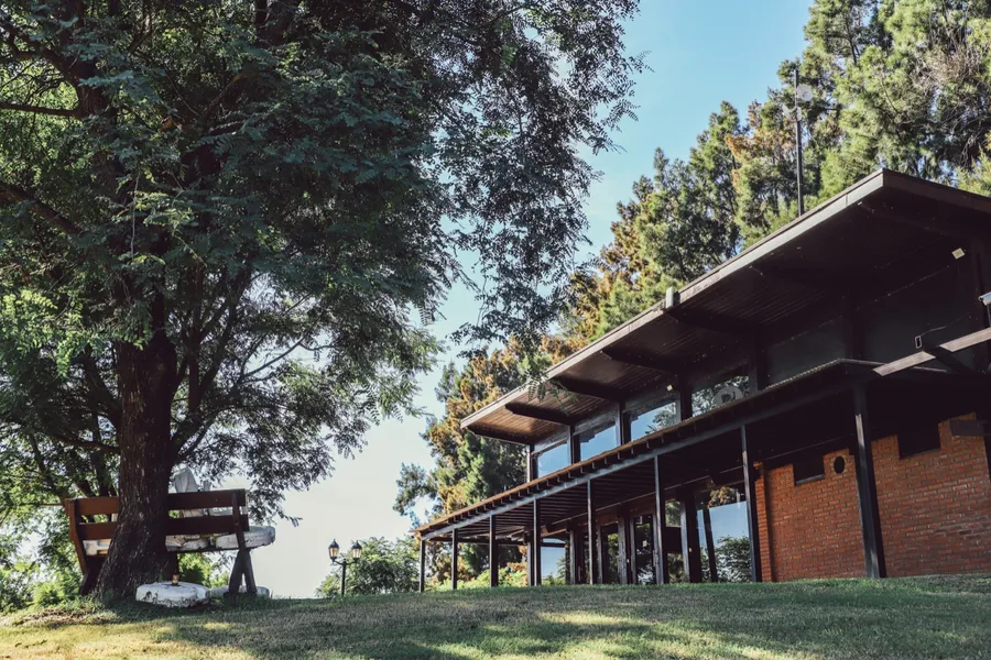 Club house de madera con galería abierta al parque